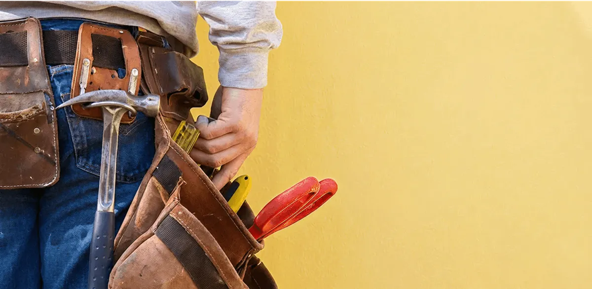 Handyman with tool belt ready for home repairs and maintenance in San Francisco, CA
