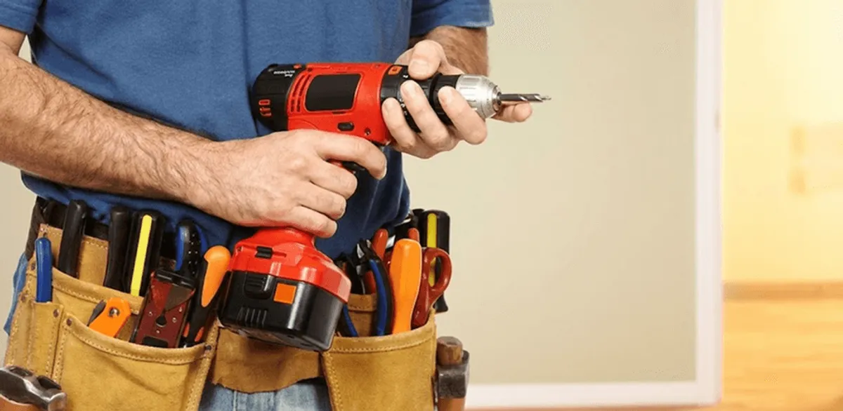 Handyman holding a power drill for home repairs and installations in San Francisco, CA